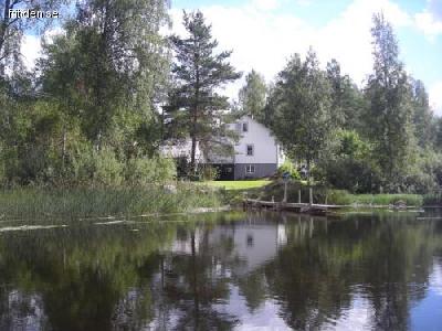 House next to a lake with boat